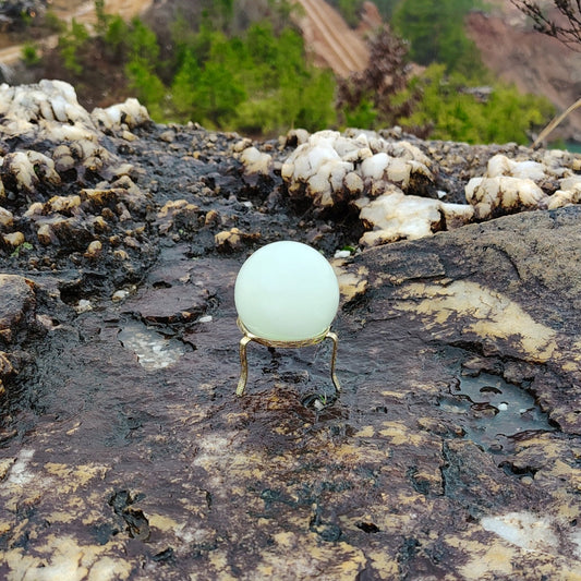 This is a polished green Calcite sphere in natural light