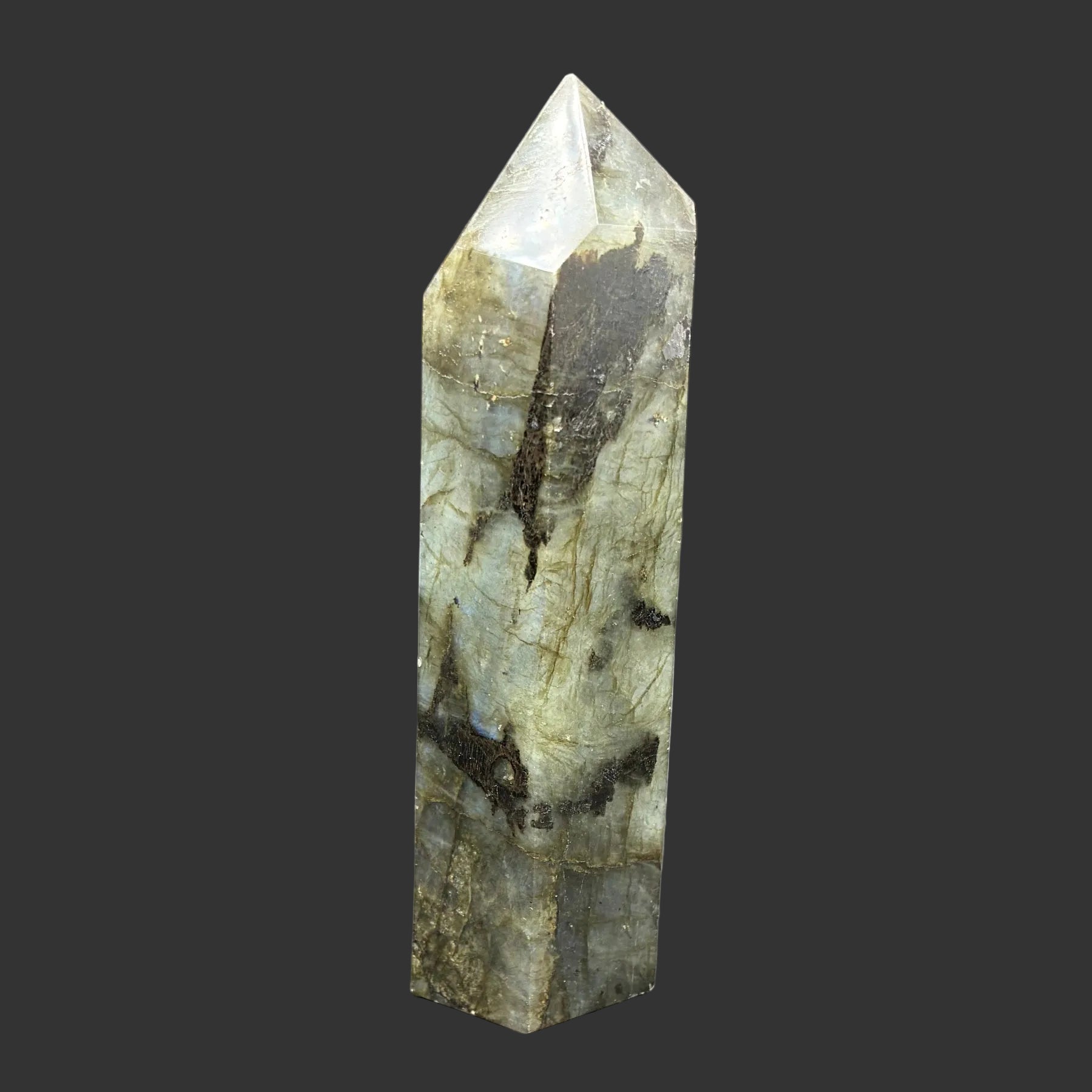 This is the left side of this polished Labradorite point. This side is mostly green with a little bit of black.
