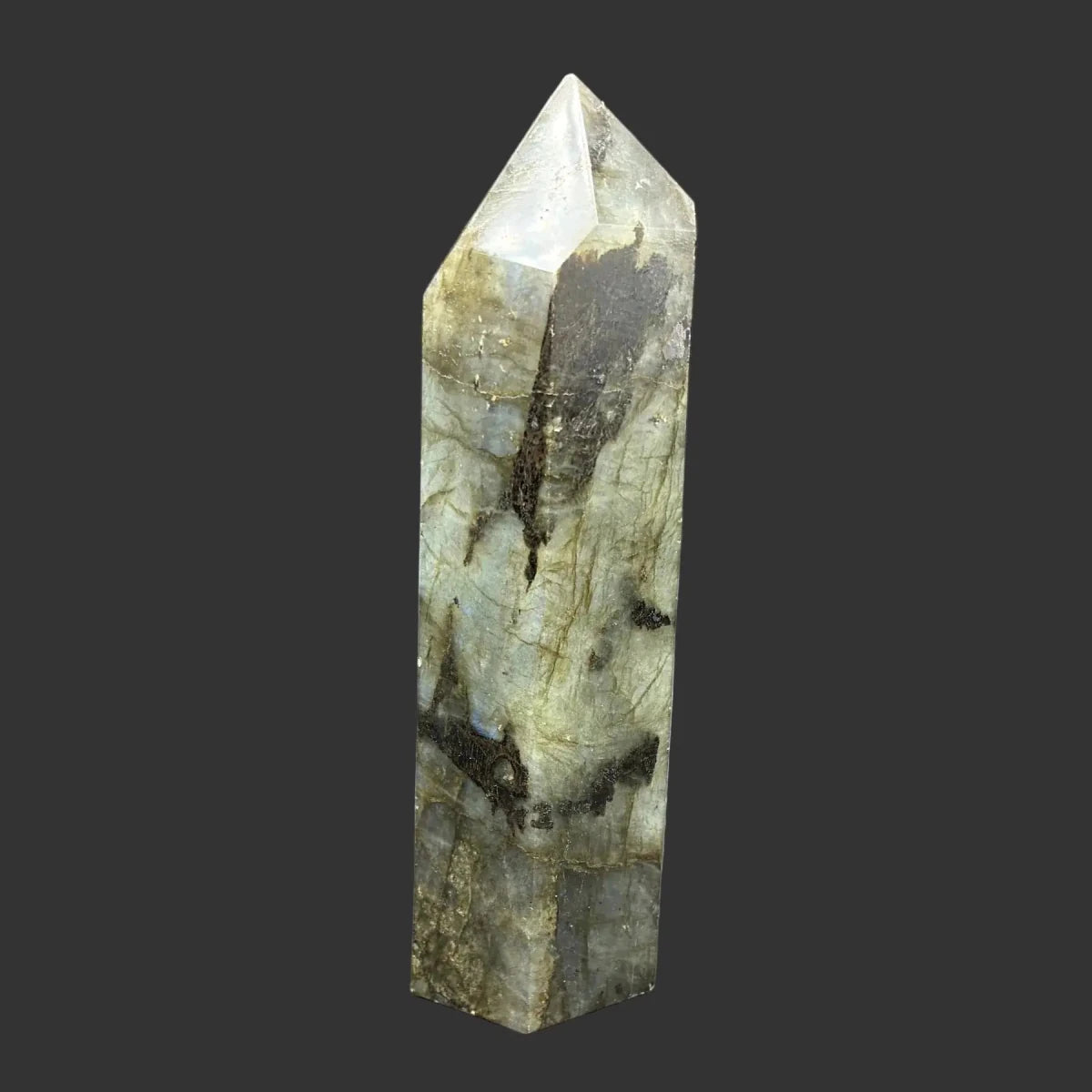 This is the left side of this polished Labradorite point. This side is mostly green with a little bit of black.