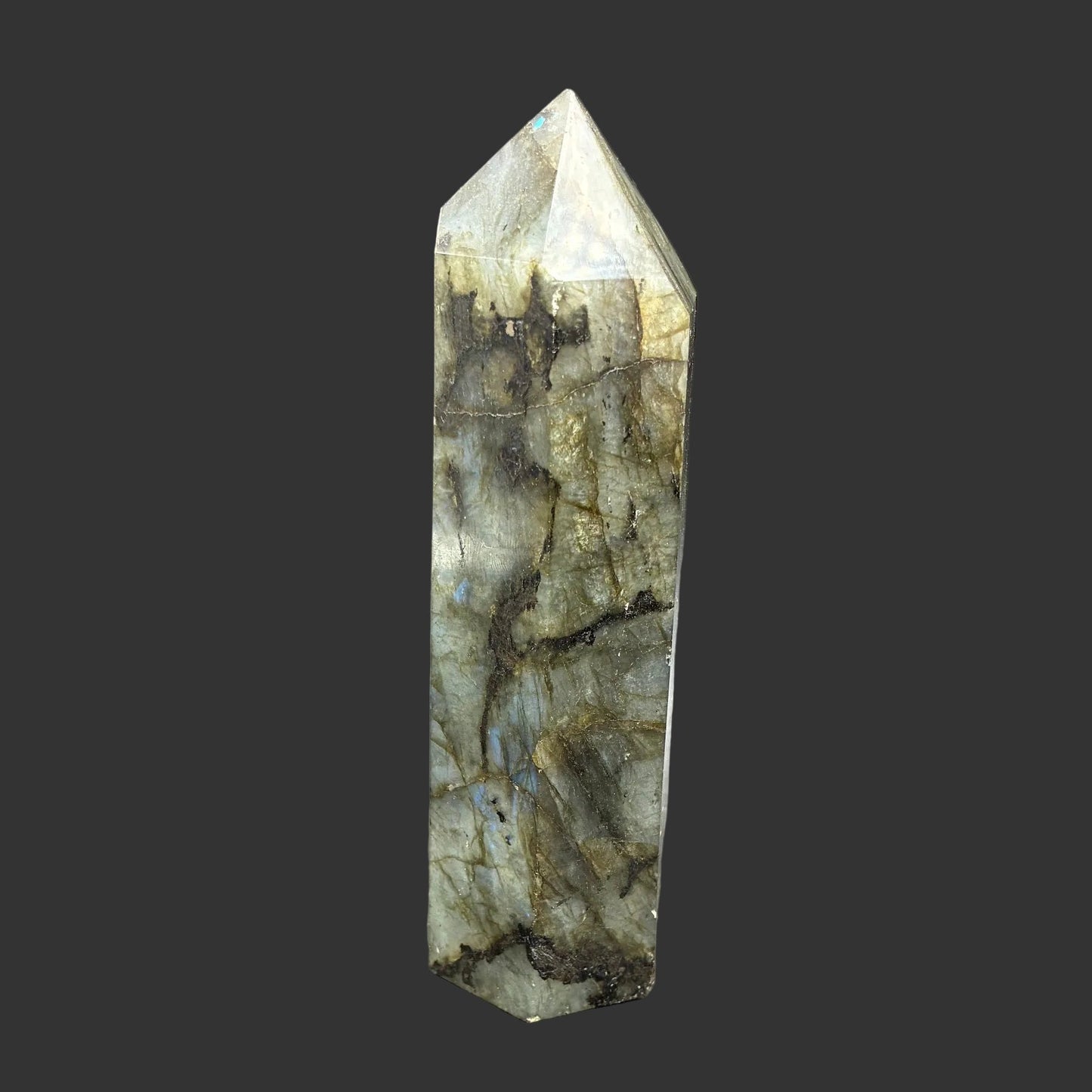 This is the right side of this polished Labradorite point, It is mostly green with some black in color.