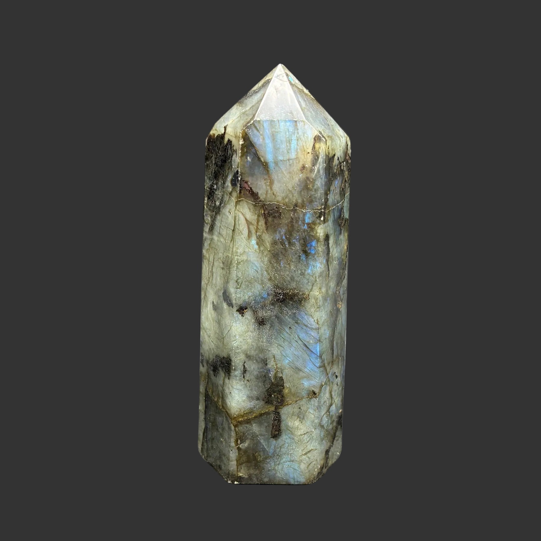 This is the back side of this polished Labradorite point. It is mostly green, with a little blue and yellow in color.