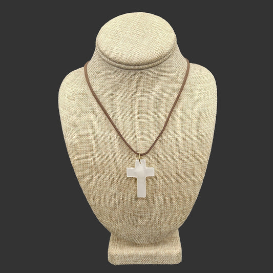This is a polished cream-colored cross on a brown leather necklace.