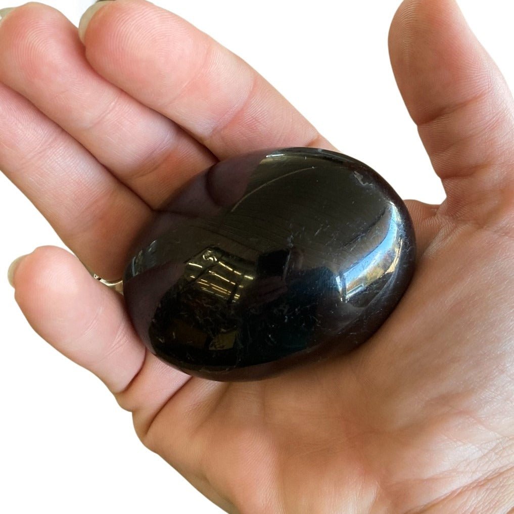 Black Tourmaline Palm Stone In Natural Light