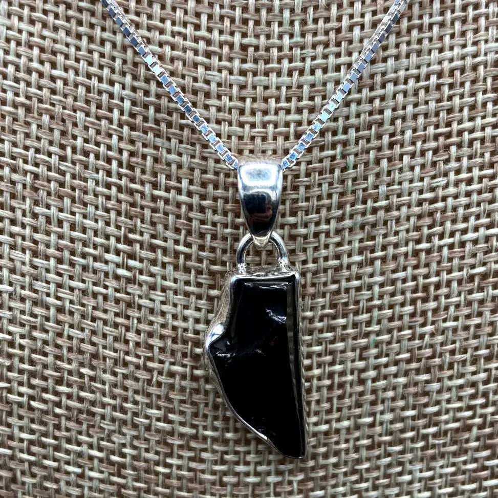 Close Up Of Shungite Pendant And Box Chain