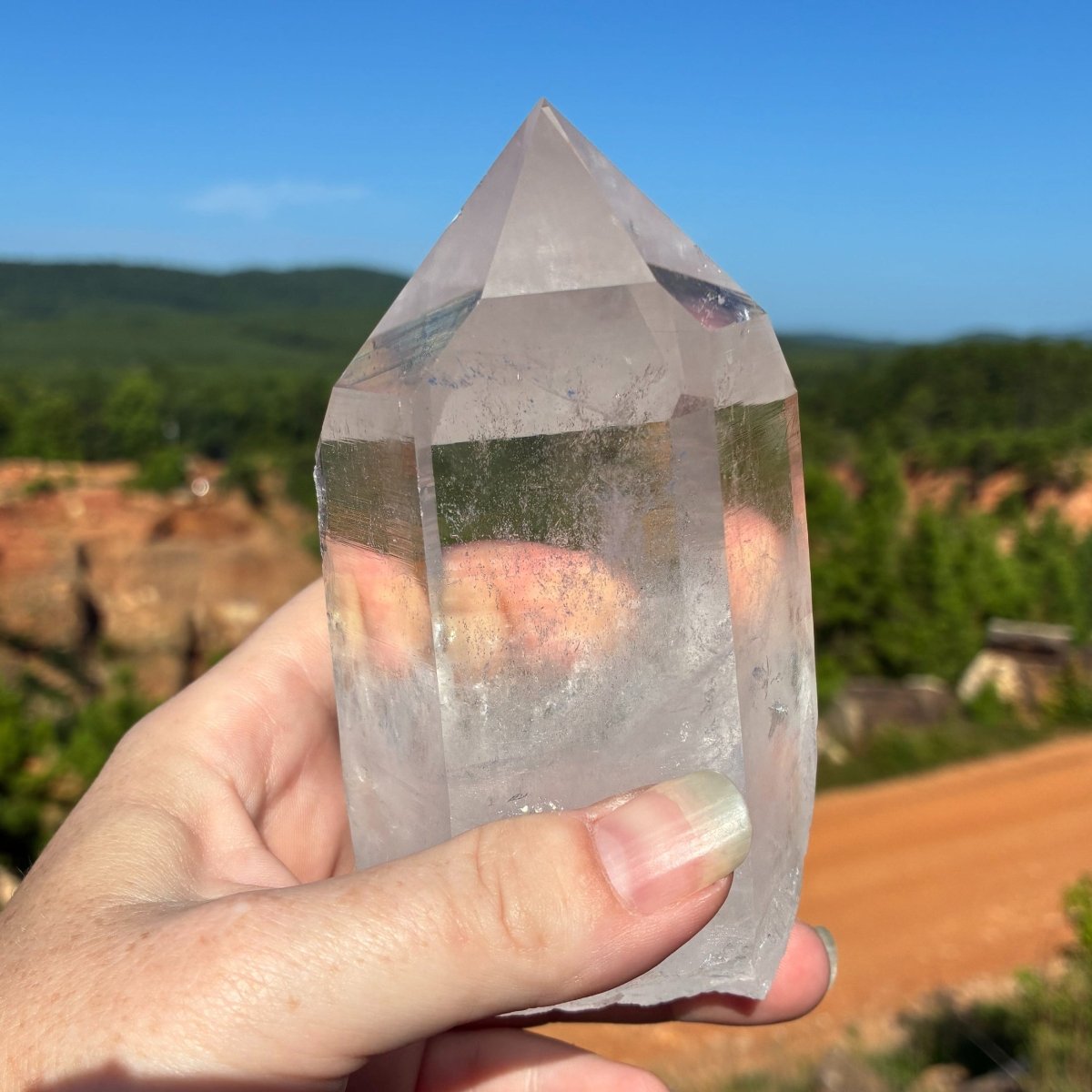 Back side of this water clear quartz crystal point, in a outdoor setting.