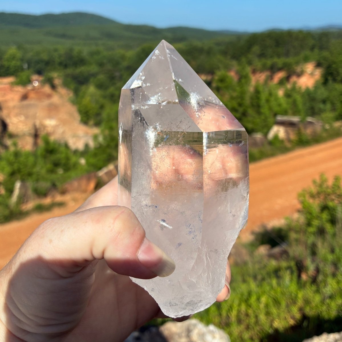 Right side of this water clear quartz crystal point, in a outdoor setting.