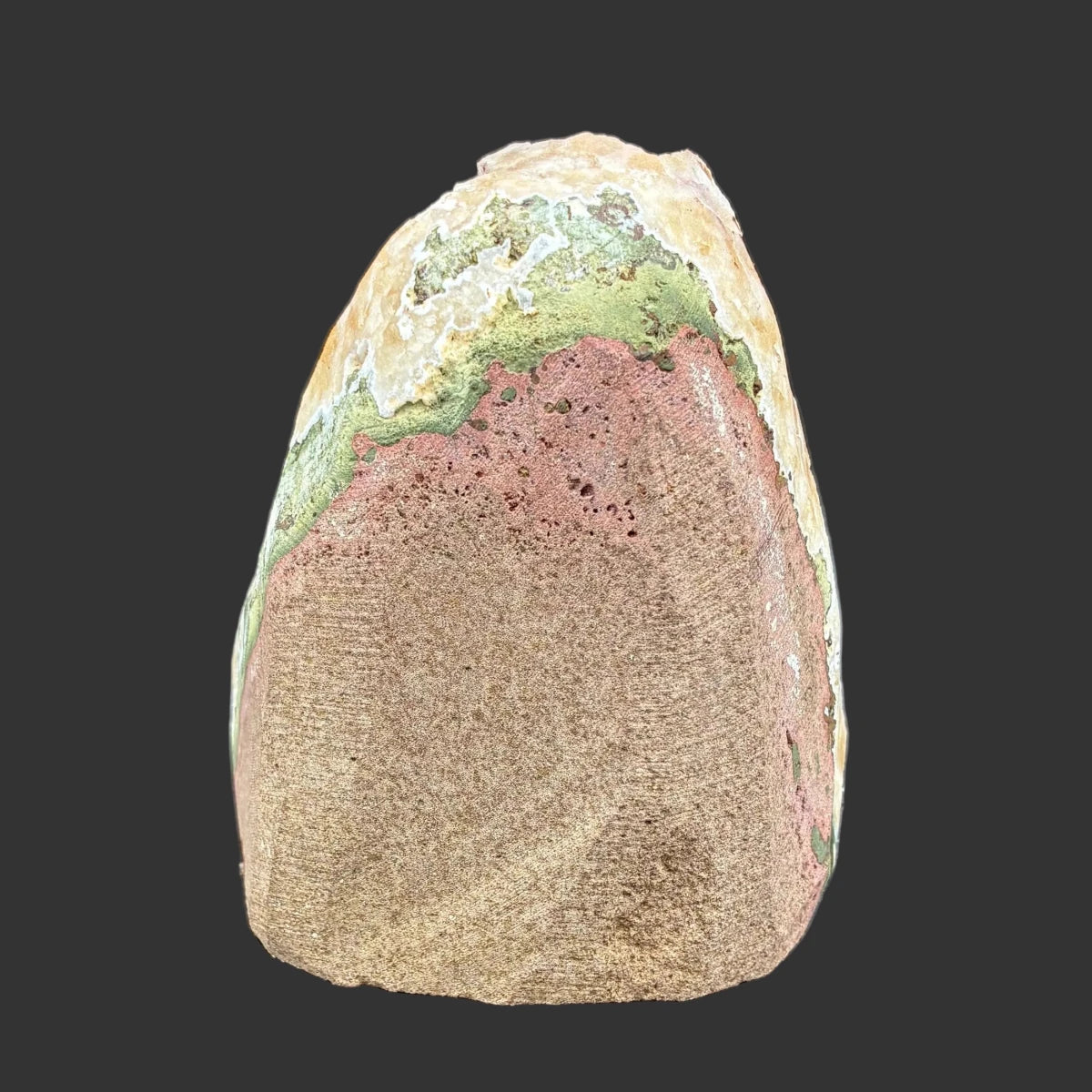 Back side of this citrine specimen, in front of a black background.