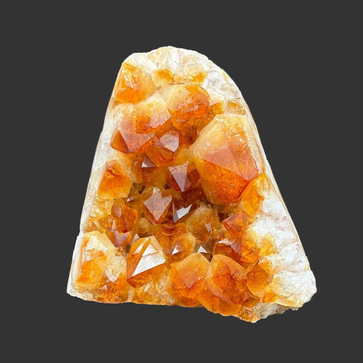 Front side of this piece of citrine, in front of a black background.