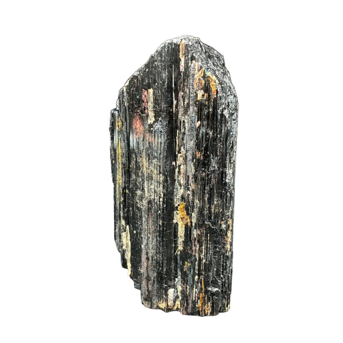 Left side of this raw black Tourmaline cut base piece, in front of a white background.