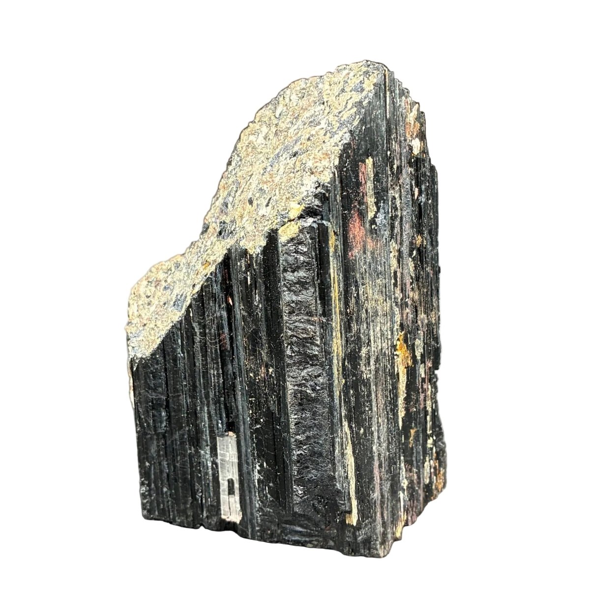 Front side of this raw black Tourmaline cut base in front of a white background.