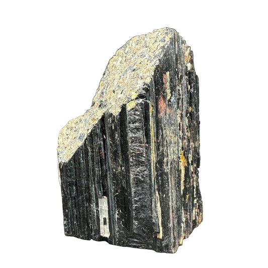 Front side of this raw black Tourmaline cut base in front of a white background.