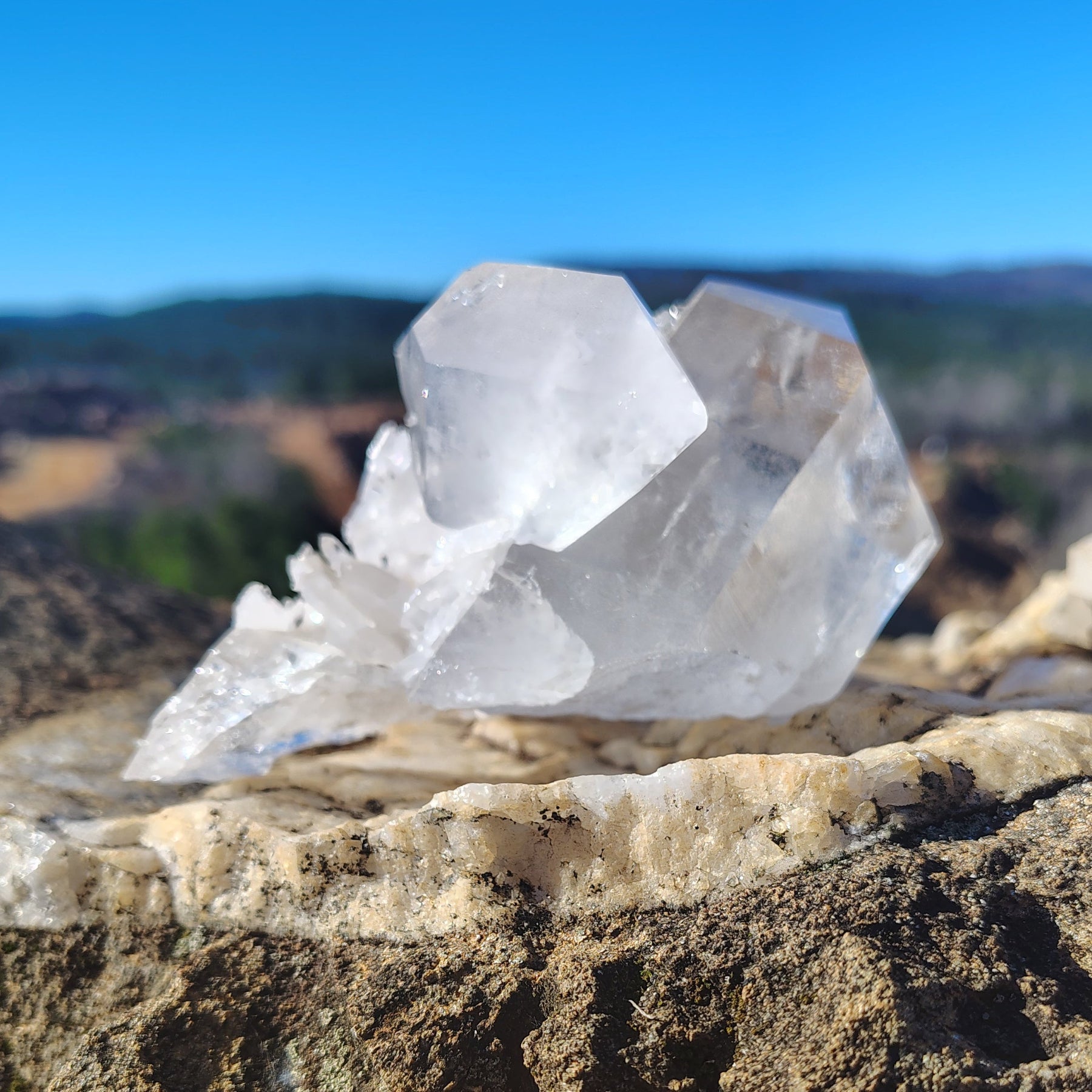 This is the left side view of this Quartz crystal cluster, in a outdoor setting.