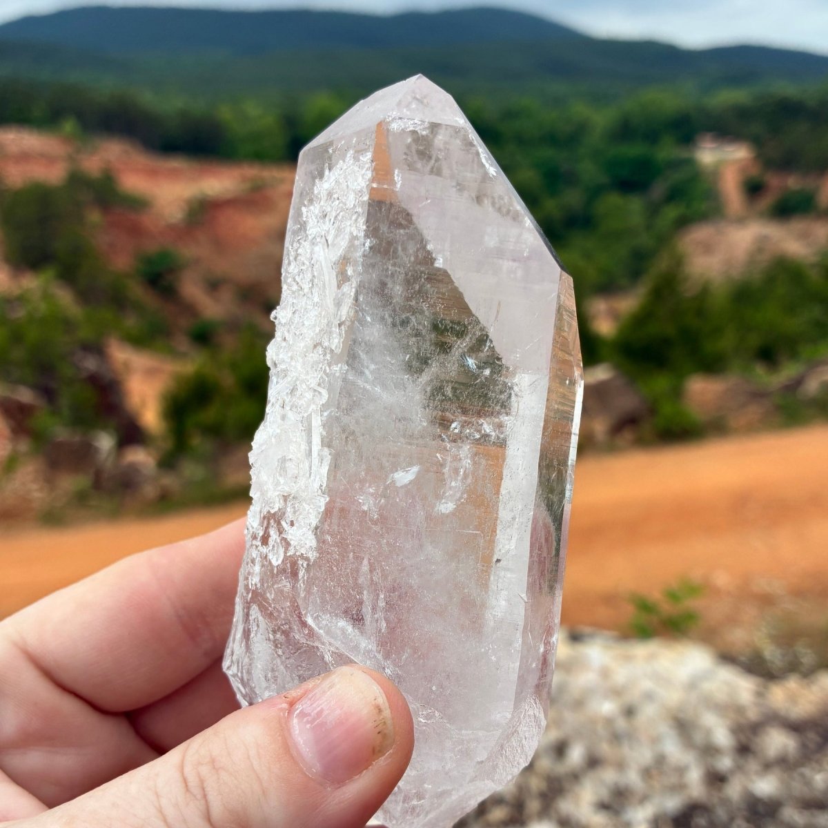 Right side of this clear Quartz crystal point, outdoors in front of the Ron Coleman crystal mine.