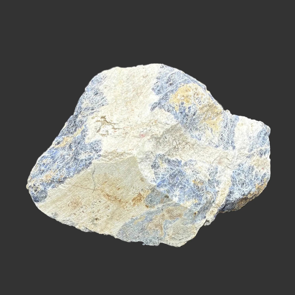 One of the Sodalite rocks that is included in this set, in front of a black background.
