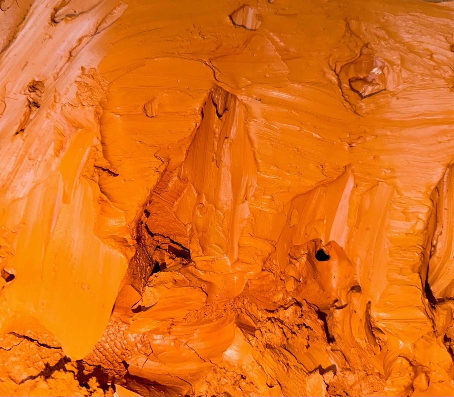 Close-up of red clay in a bucket. 