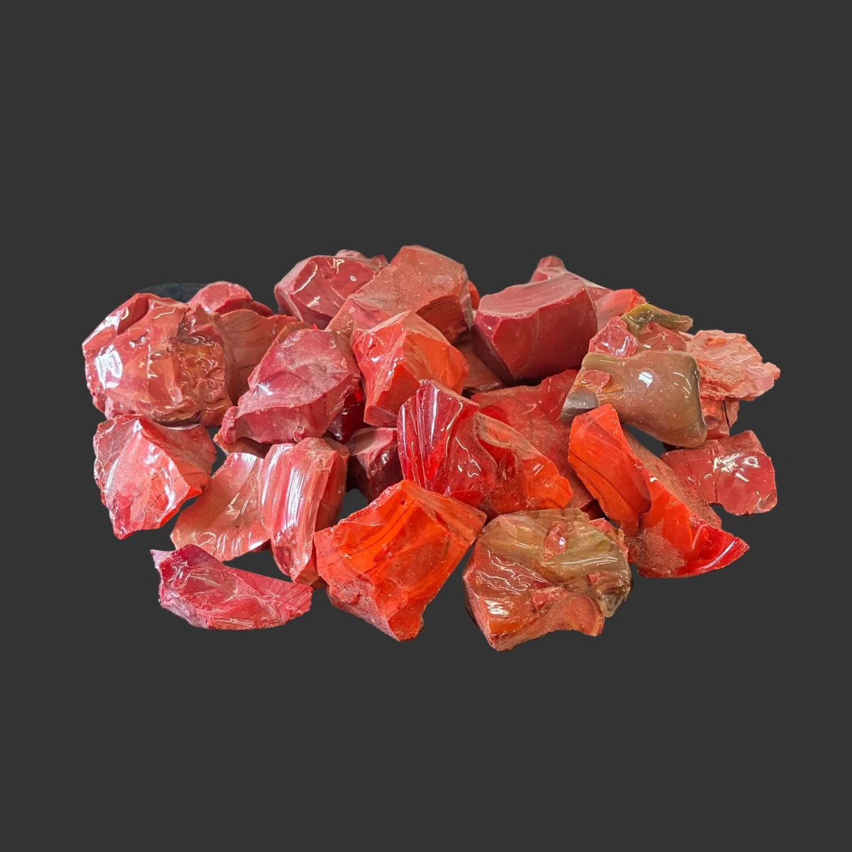 Bulk view of red and orange slag glass, in front of a black background.