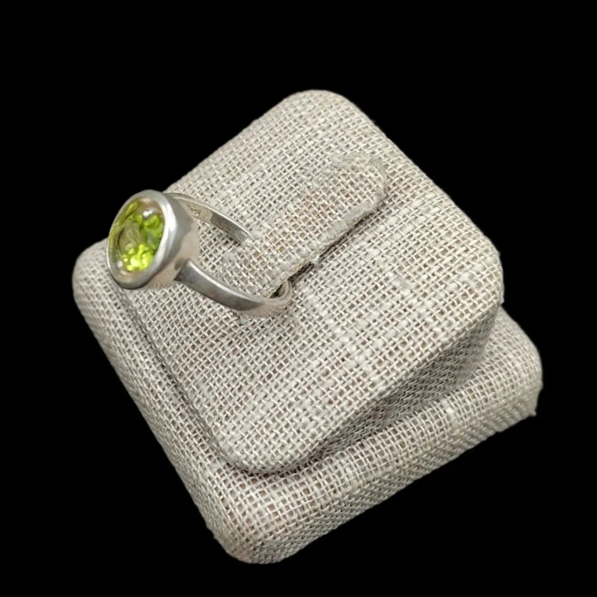 This is another angle of this Peridot ring on burlap display stand