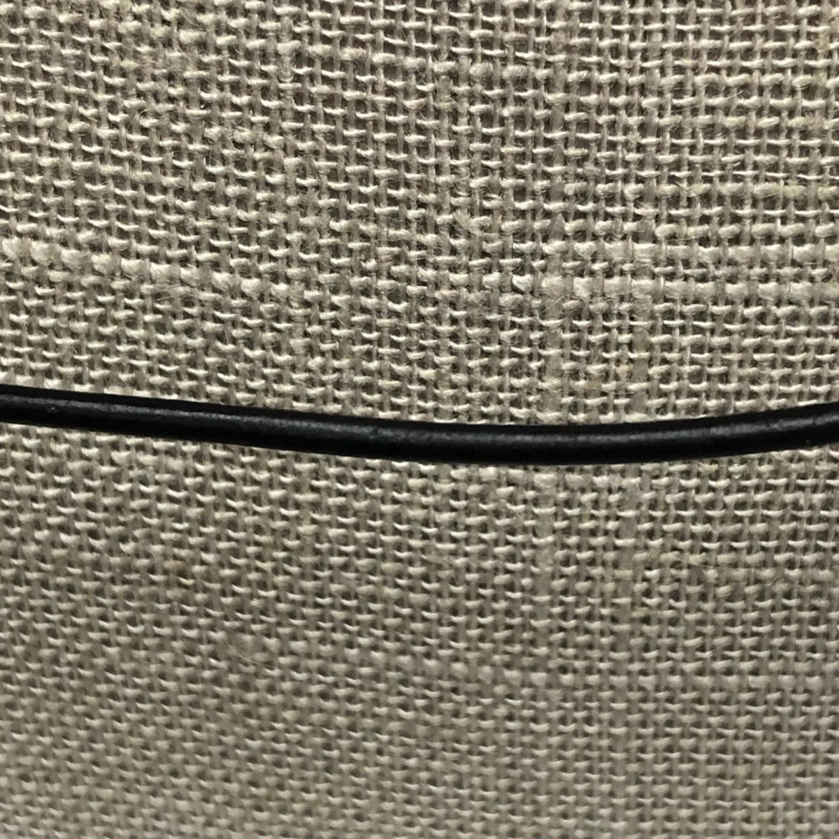 Thin Black Leather Cord Necklace Close Up On Burlap Neck Display
