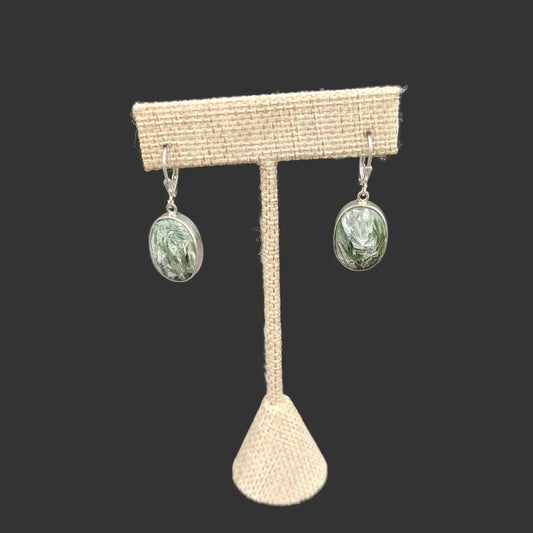 The front side of these Seraphinite earrings are Sterling Silver and the oval-shaped gemstones are green and white.