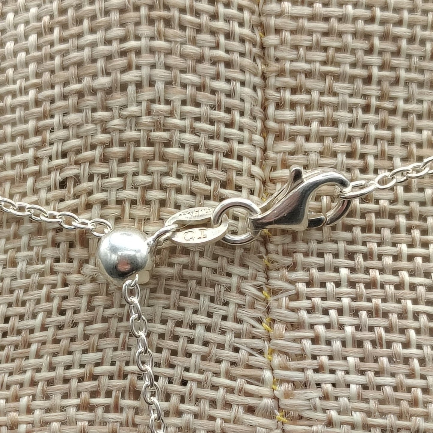 This is a close up of the sterling silver lobster claw clasp on this adjustable necklace.