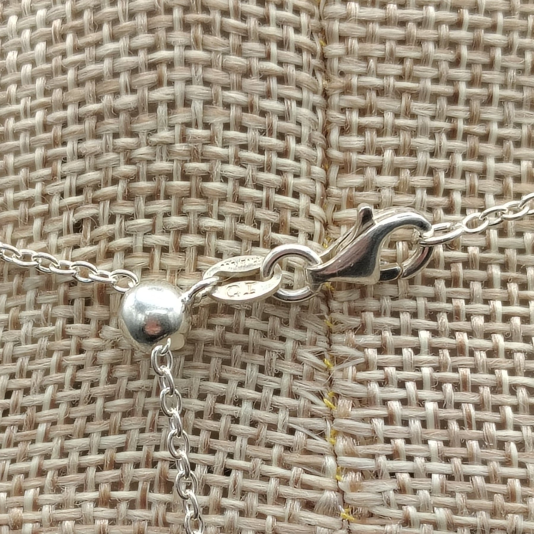 This is a close up of the sterling silver lobster claw clasp on this adjustable necklace.