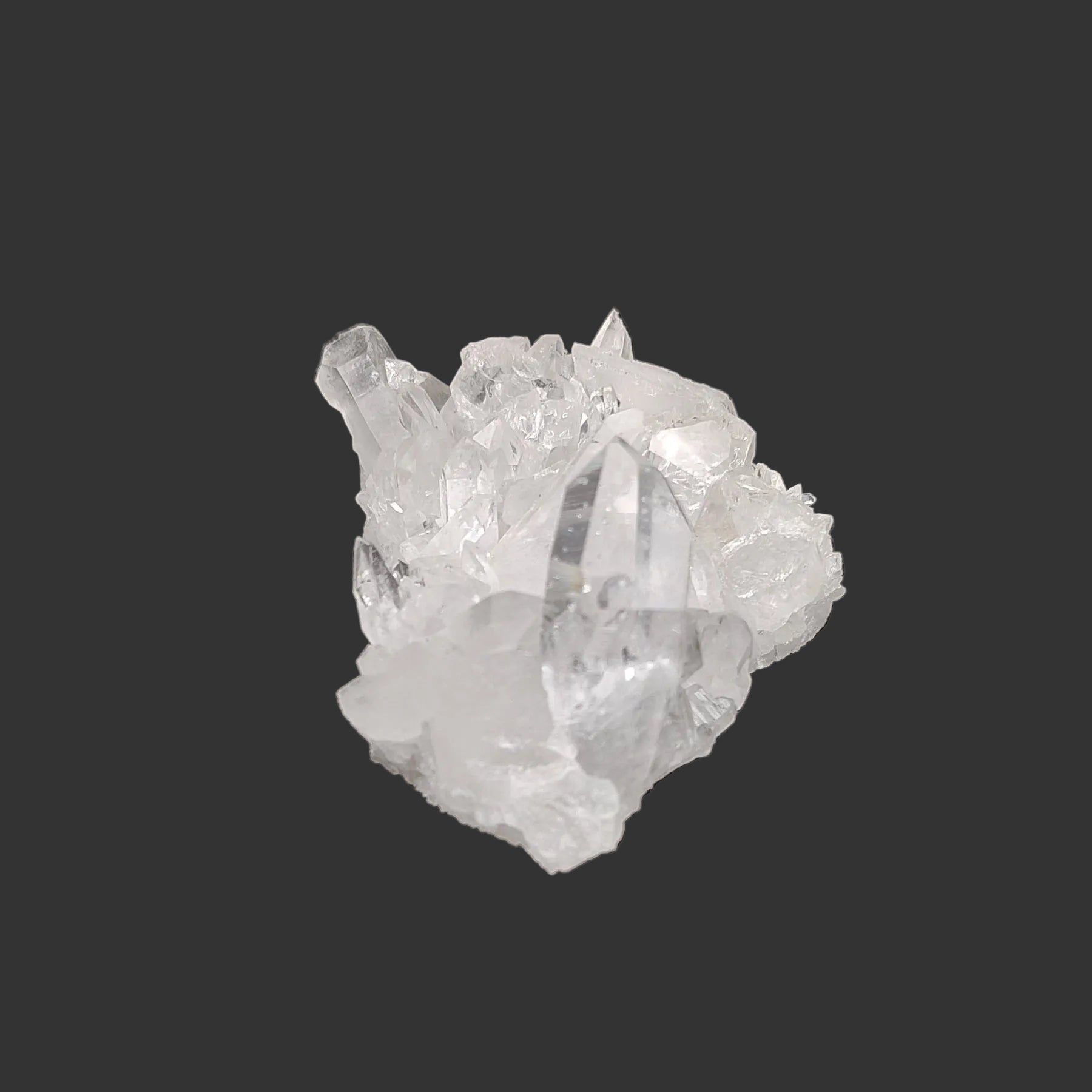 This is the left side of this small clear Quartz crystal cluster in artificial light.
