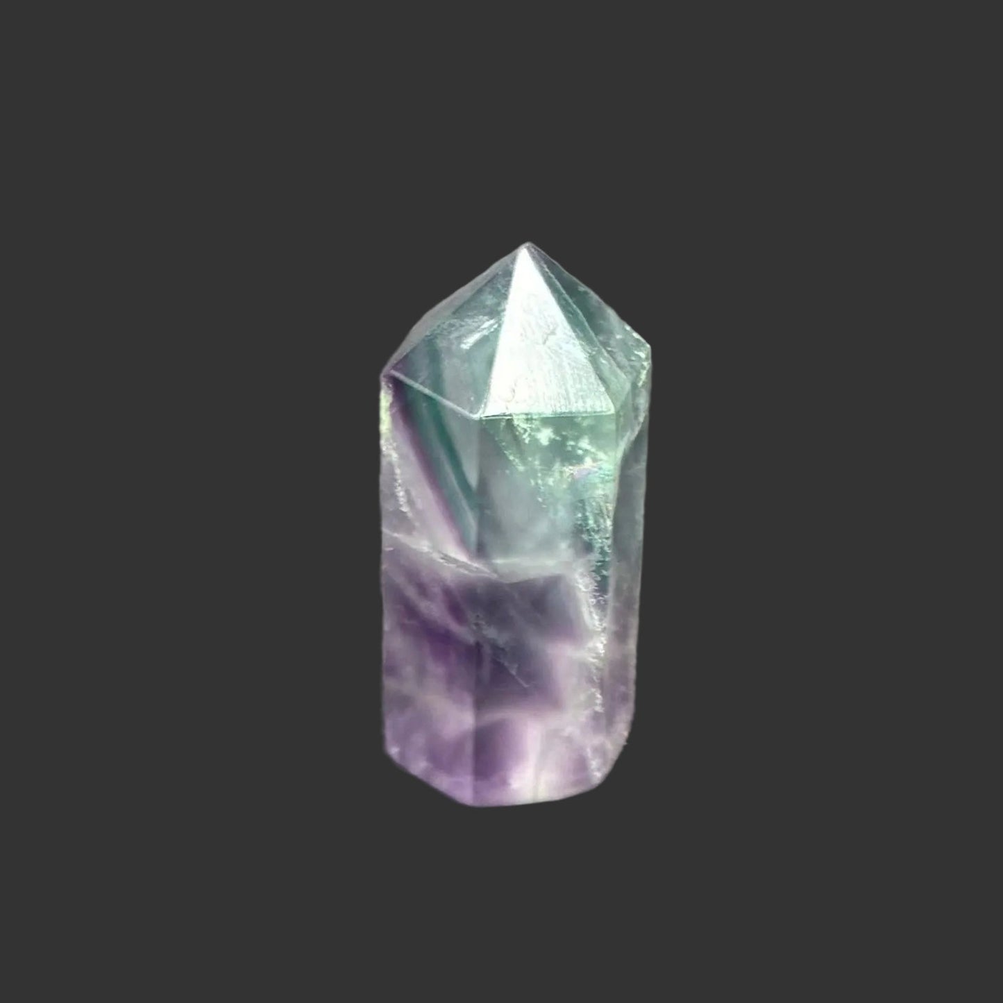 This is the side of this green and purple fluorite tower. 