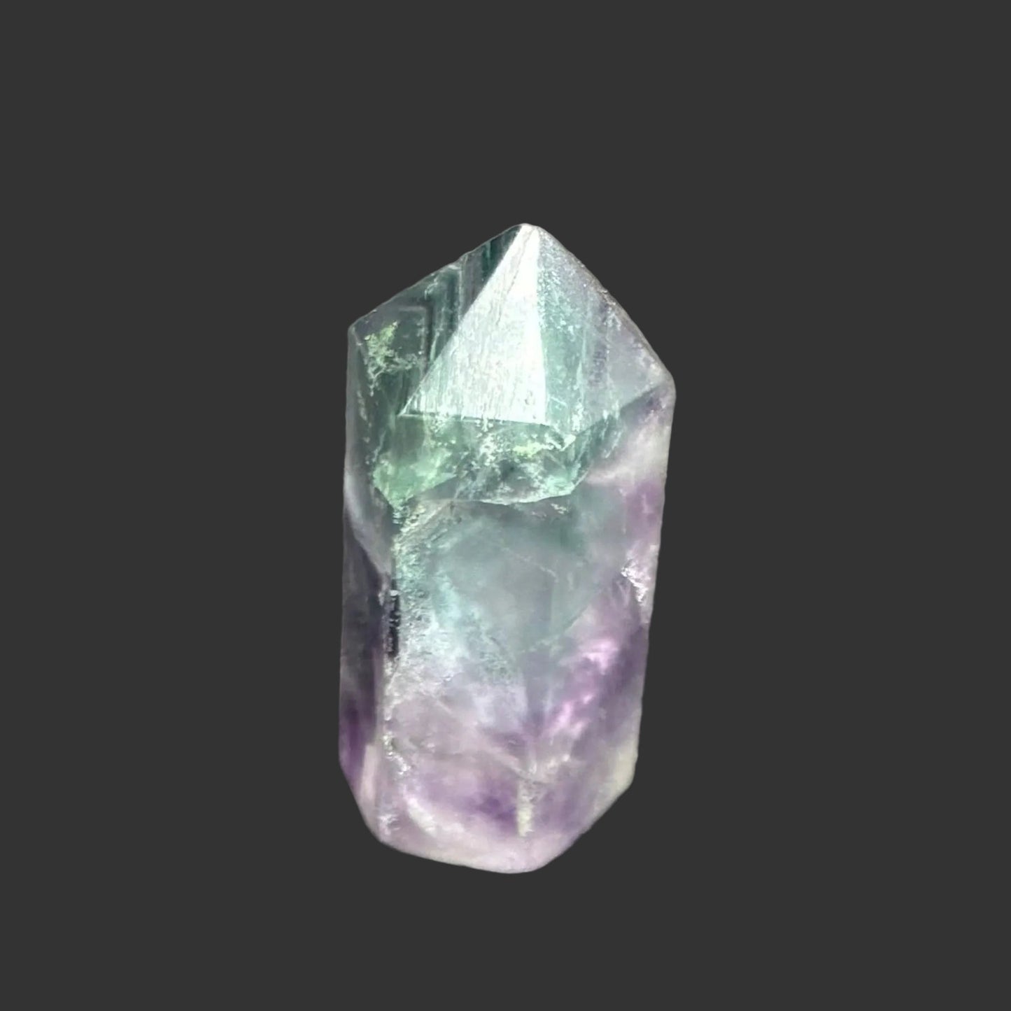 This is the back side of this polished green and purple fluorite tower.