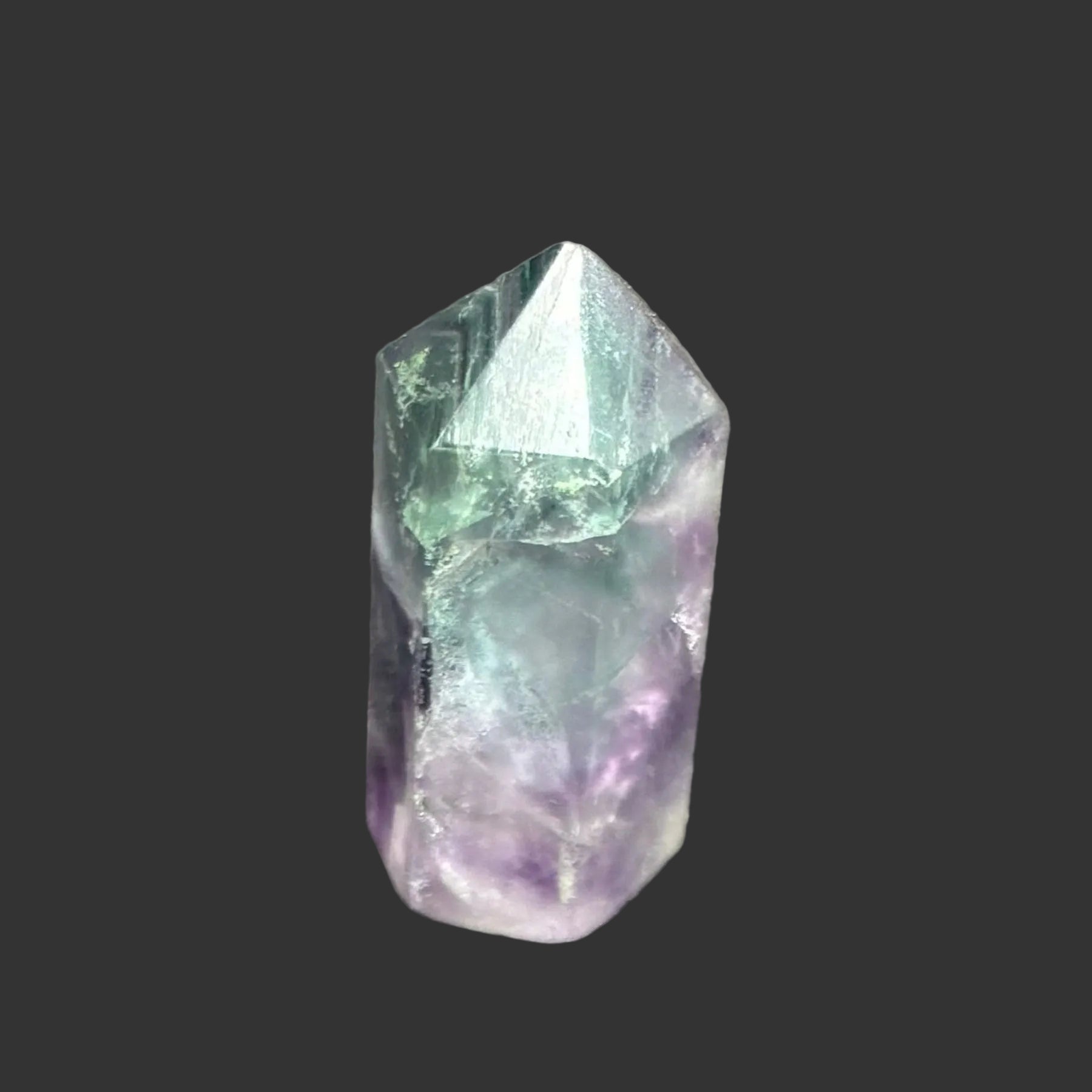 This is the back side of this polished green and purple fluorite tower.