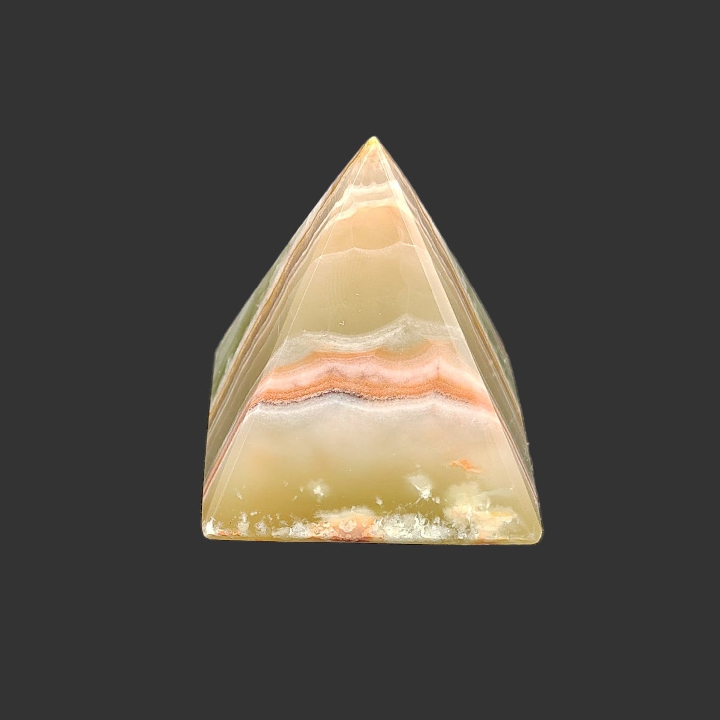 The back side is covered in more striations going from left to right, in the colors of green, cream, and orange.