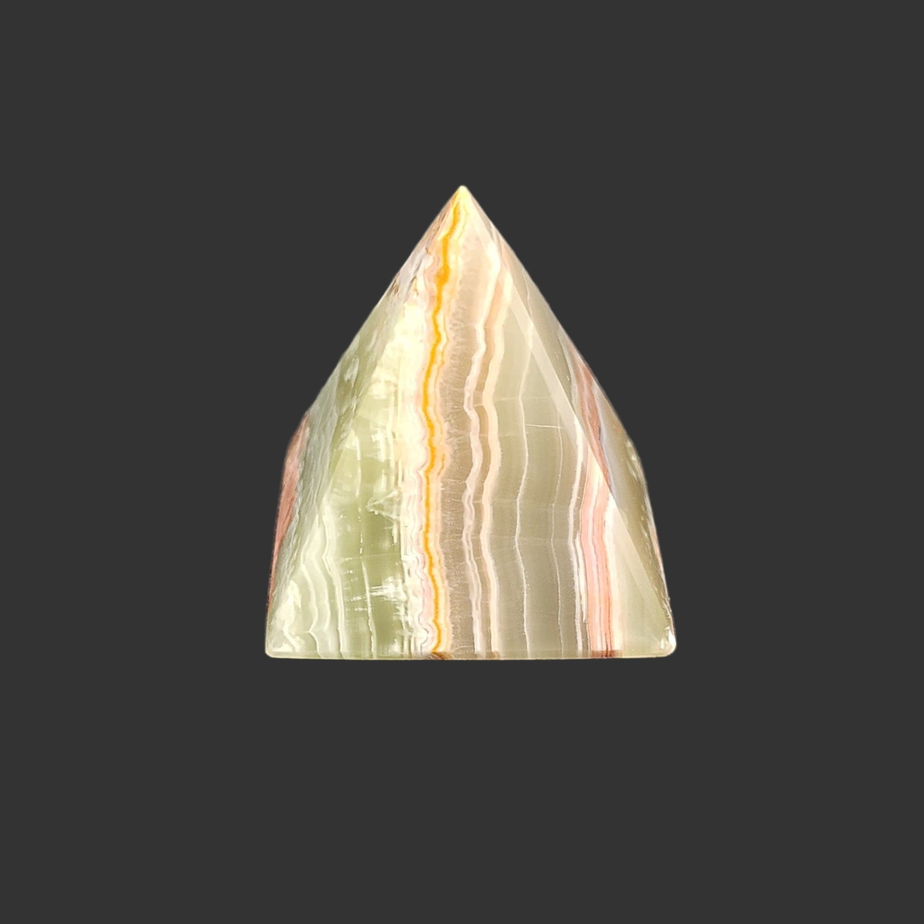 The left side of this green onyx pyramid is covered in bilateral lines of green, orange, and cream.