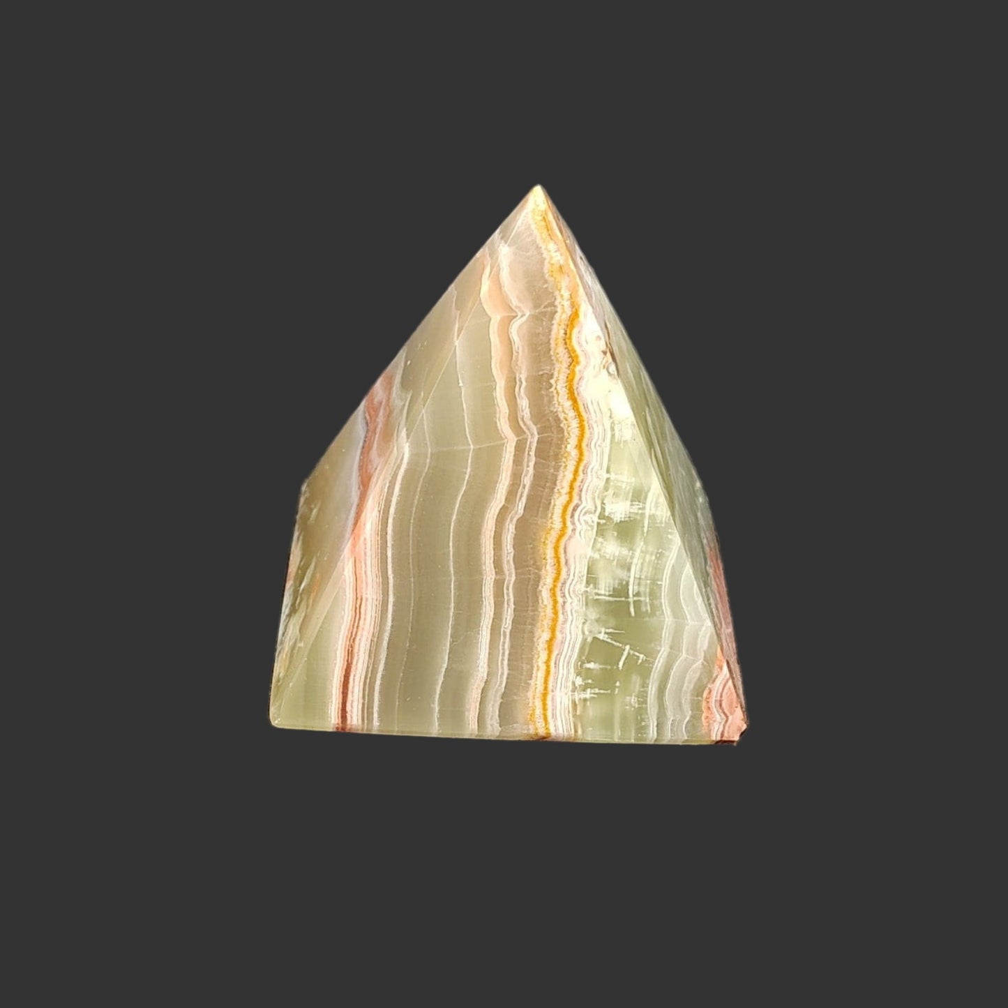 On the back side you can see more bilateral striations of green, orange, and cream.