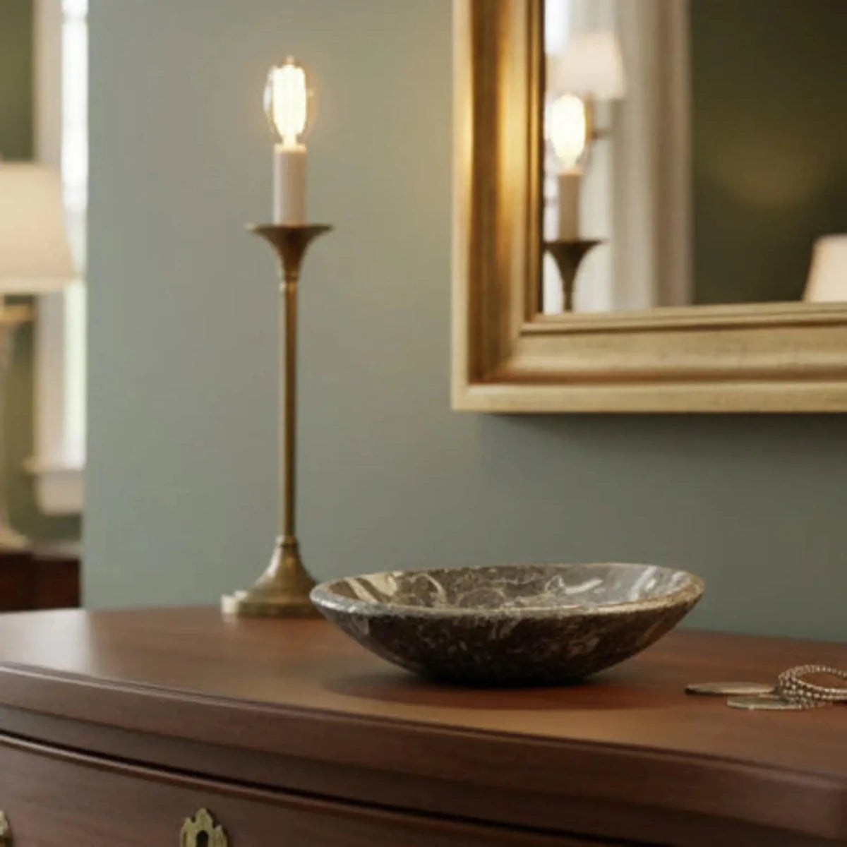 Small trinket bowl with authentic 
Ammonite fossils throughout, on top of a dresser.