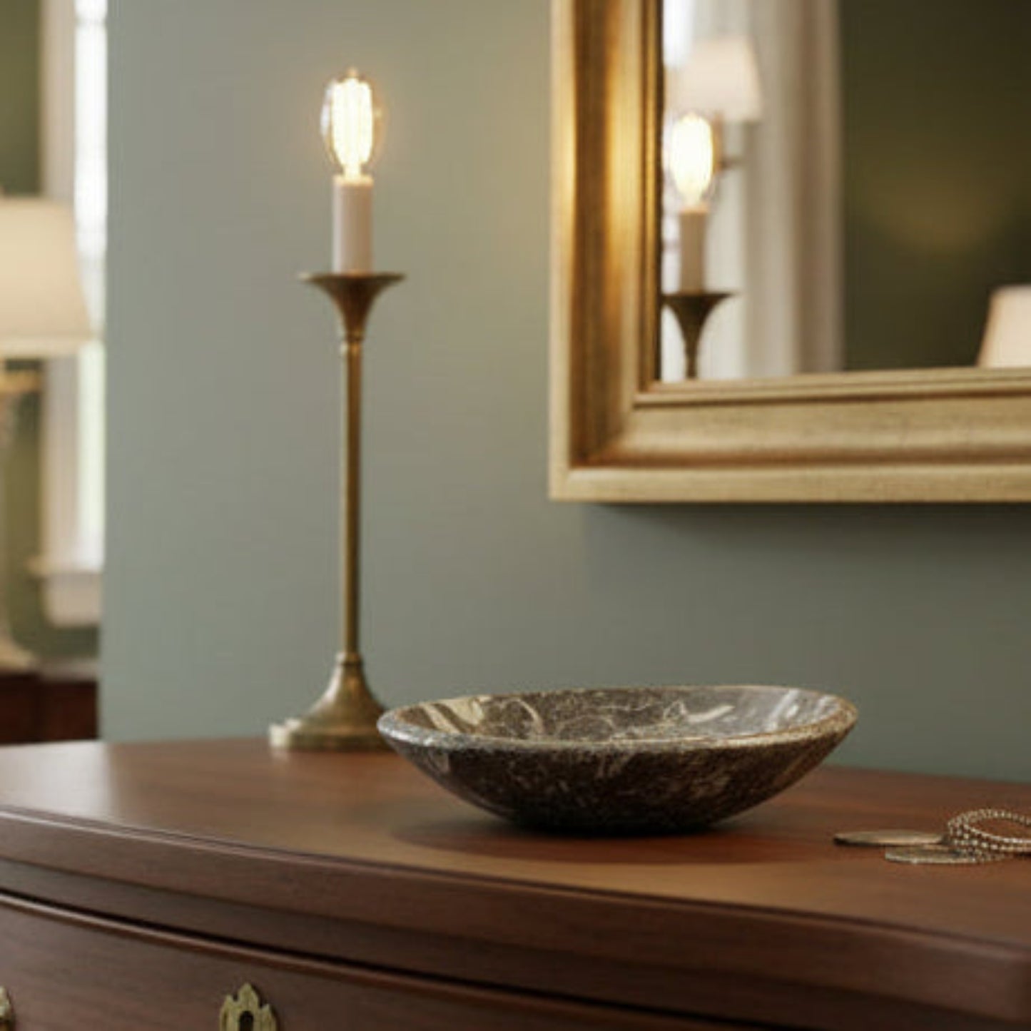 Small trinket bowl with authentic 
Ammonite fossils throughout, on top of a dresser.