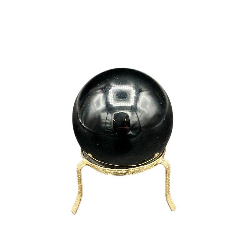 Back Side Of Polished Glossy And Smooth Black Obsidian Sphere