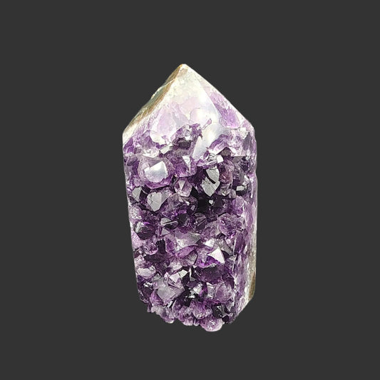 The front side of this small tower is covered in purple Amethyst Quartz crystals.