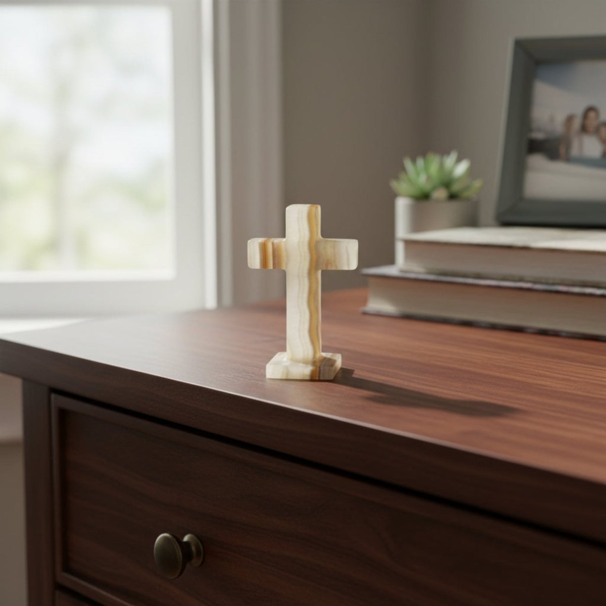Polished banded Onyx cross sitting on top of a dresser.