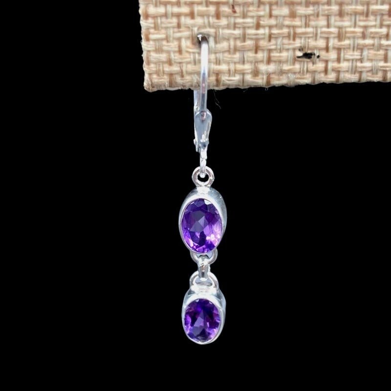 Close Up Of Sterling Silver And Amethyst Gemstone Dangle Earrings, Each Earring Has 2 Gemstones On It, They are Small ,Oval Cut And Deep Purple