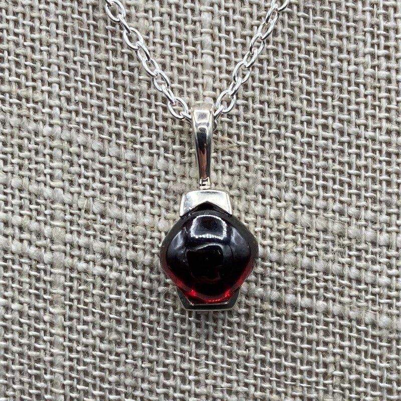 Close Up Of Sterling Silver And Modest Garnet Pendant Necklace, Garnet Gemstone Is A Deep Red