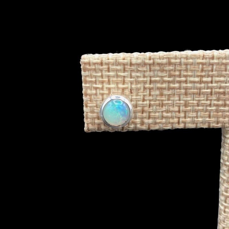 Close Up Of Sterling Silver And Opal Gemstone Stud Earrings, Gemstone Is A Iridescent White