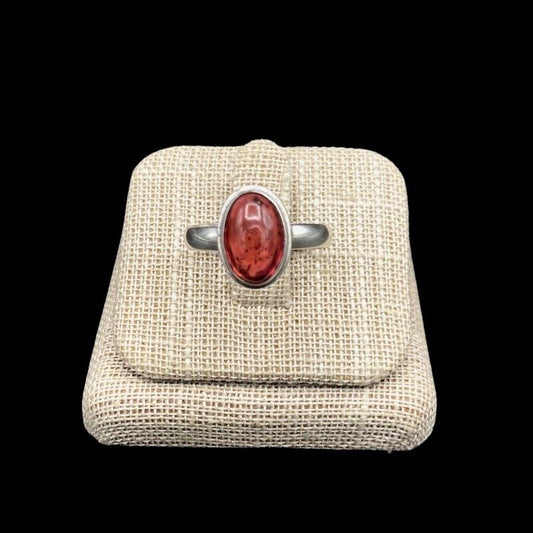 Front View Of Sterling Silver And Oval Shaped Tourmaline Gemstone Ring, Band Is Polished Silver And The Gemstobne Is A Shiny Pink Mauve