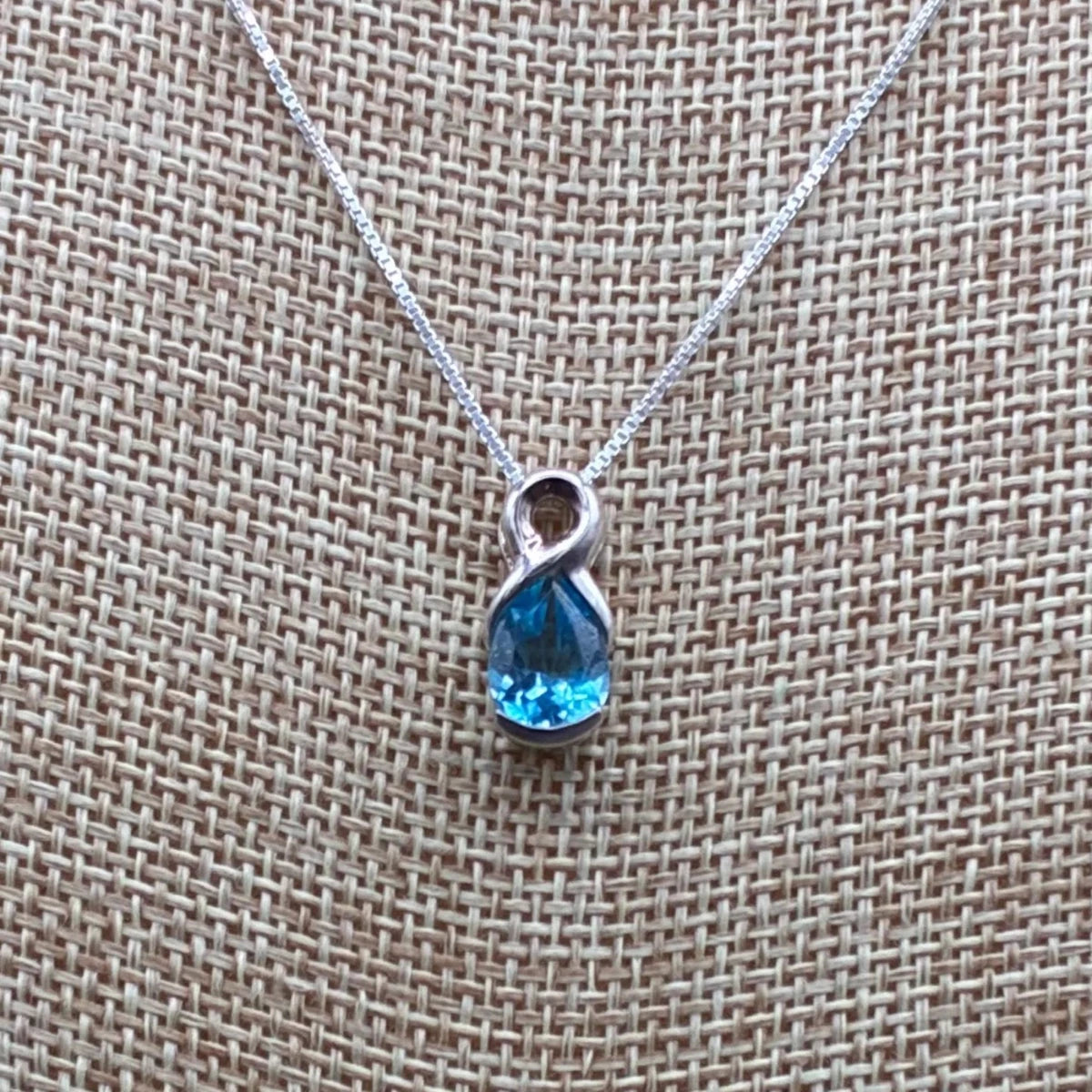 Close up of the blue topaz and sterling silver pendant.