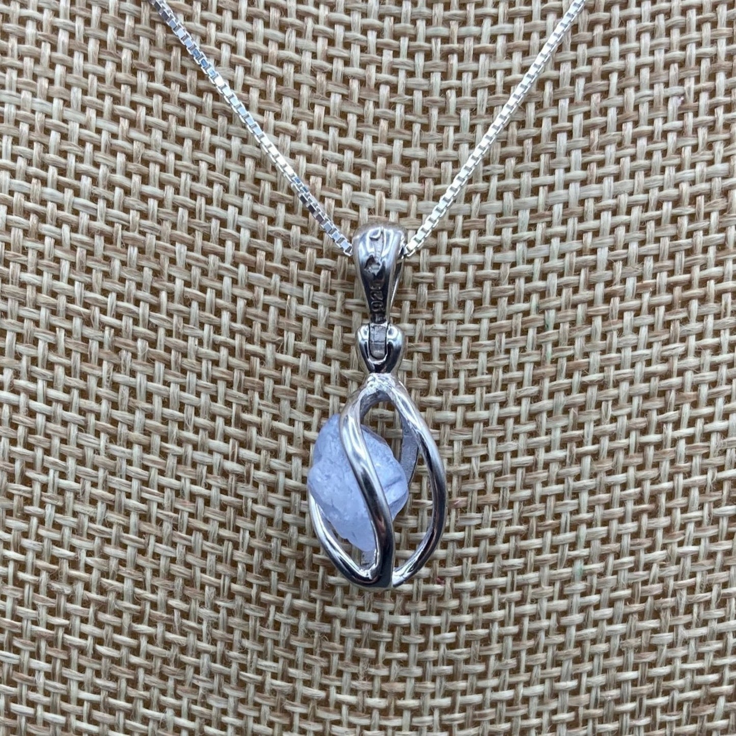 Close up of blue dumortierite Quartz in Sterling Silver cage pendant