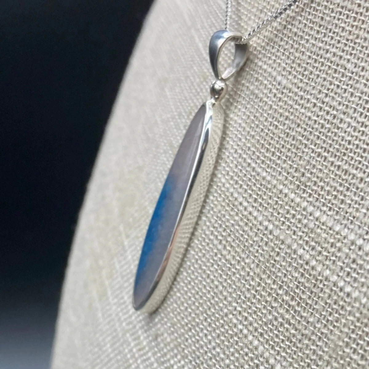 Side view of blue Dumotierite Quartz pendant