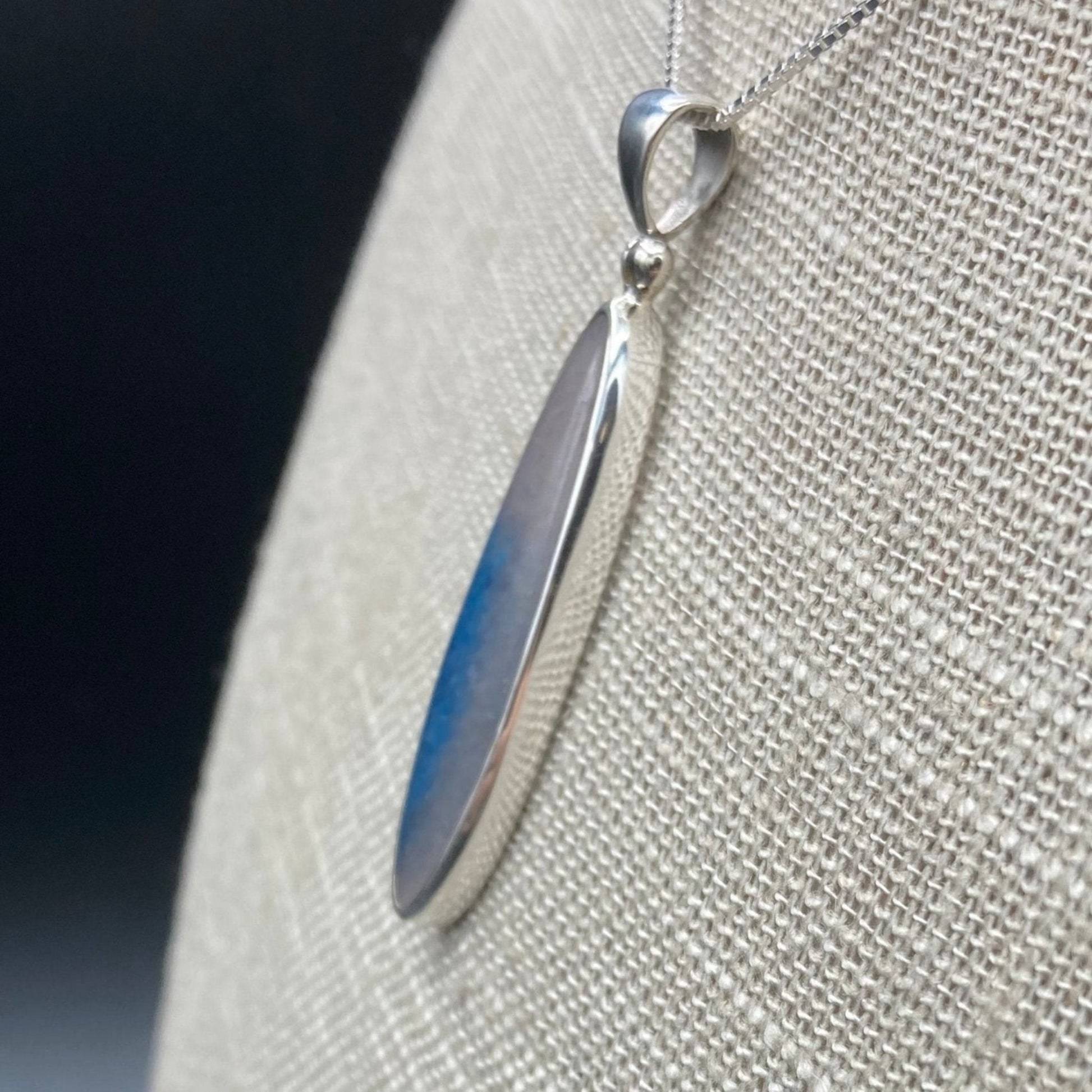 Side view of blue Dumotierite Quartz pendant