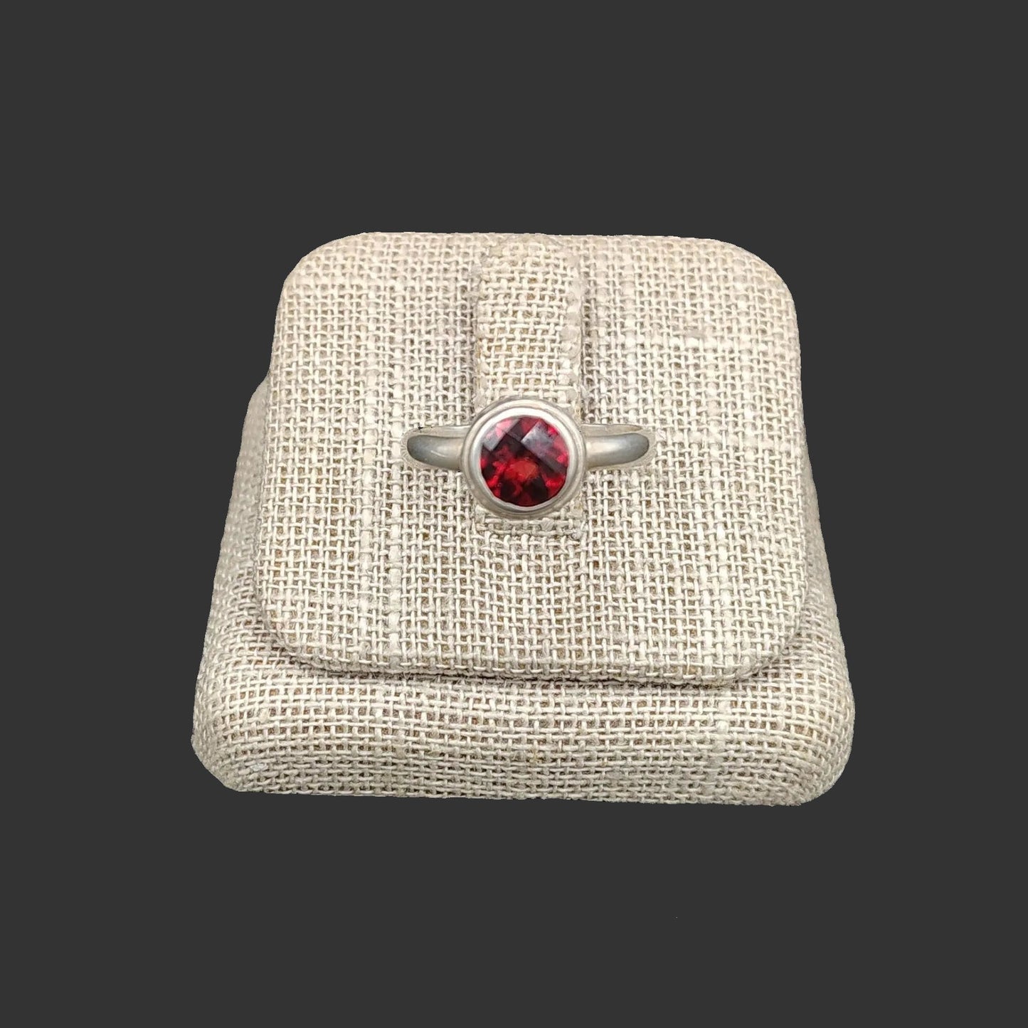 This Sterling Silver red Garnet ring is circular in shape.