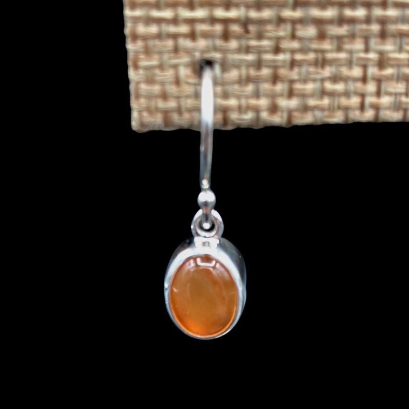 Close Up Of Sterling Silver Carnelian Gemstone Dangle Earrings, Smooth Silver, Oval Shaped And Bright Orange