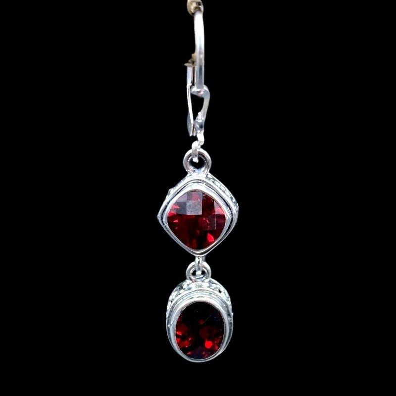 Close Up Of Sterling Silver Oval And Diamond Shaped Garnett Gemstone Dangle Earrings, Gemstones Are a Deep Red