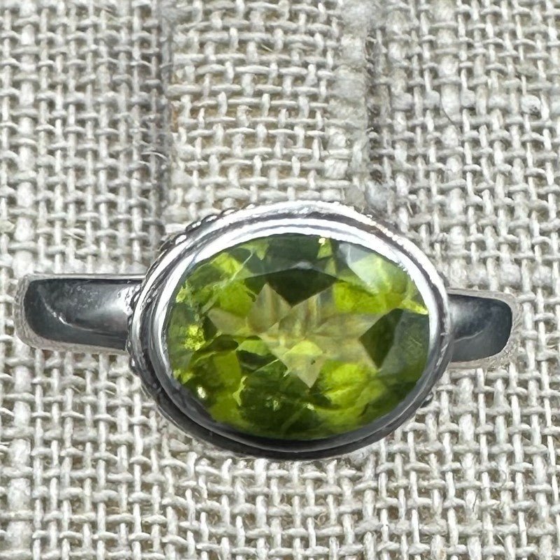 Close Up Of Green Peridot Gemstone On Sterling Silver Ring