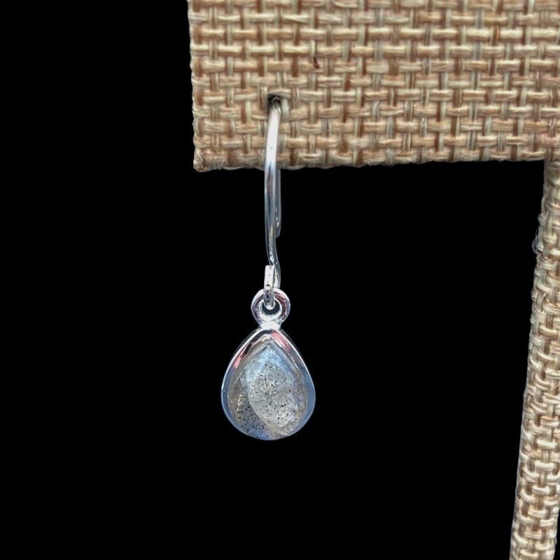 Close Up Of Sterling Silver Pear Shaped Labradorite Gemstone Dangle Earrings, Hardware Is Silver And Gemstone Is A Clear And Grey Color With A Blue Iridescent Overlay